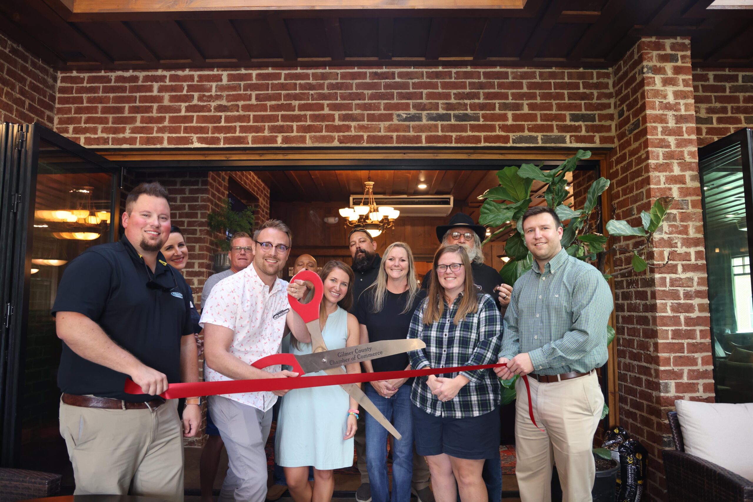 Davis Lacey cutting ribbon at Ellijay Cigars